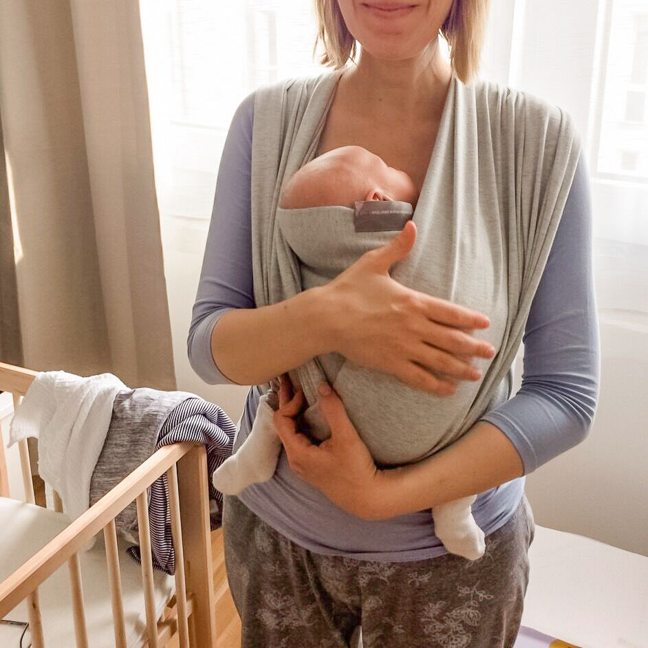 Mom wearing her baby in a stretchy wrap Mom wearing her baby in a stretchy wrap